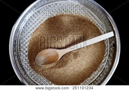 A Wooden Spoon And A Thin Brown Bulgur In A Bowl