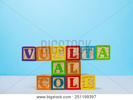 Vuelta Al Cole Translates To Back To School In Spanish With Wooden Blocksagainst Blue Background Wit
