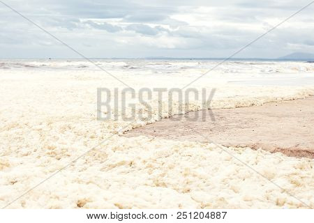 Sea And Skies And A Beach Covered In Sea Foam