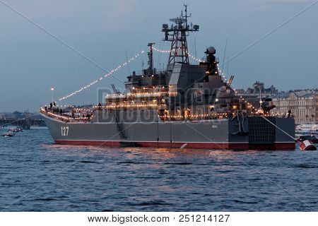 ST. PETERSBURG, RUSSIA - JULY 21, 2018: Illuminated Russian large landing craft Minsk in Neva river preparing to the parade dedicated to Navy Day. It's celebrated in the last Sunday of July