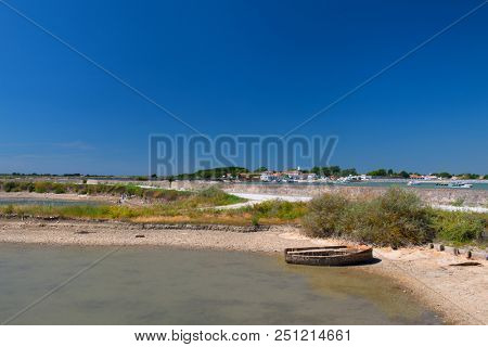 Ile de RÃ© landscape with village Loix and salt lake with boat