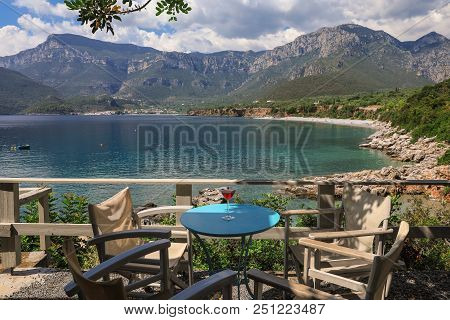A Glass Of Red Martini On The Table In The Resort Bar On The Background Of A Picturesque Seascape Of