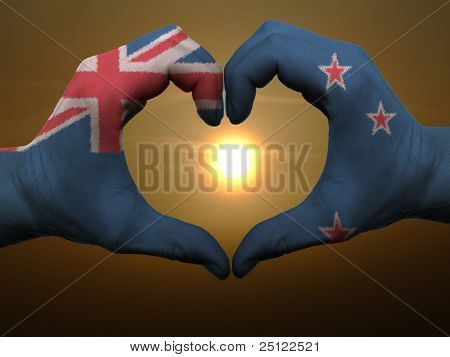 Heart And Love Gesture By Hands Colored In New Zealand Flag During Beautiful Sunrise
