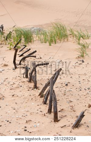 Rusted metal pieces from old pier on a beach