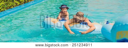 Father And Son Have Fun At The Water Park. Banner, Long Format