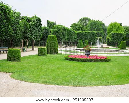 Abstract Ideal Flower Beds And Shorn Trees In A Well-kept Park