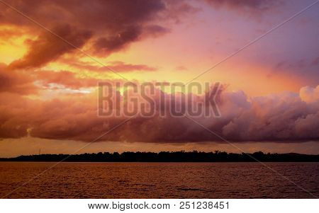 Summer Sunset With Predominately Cumulusclouds Against A Yellow And Lilac Sky Reflected In Australia