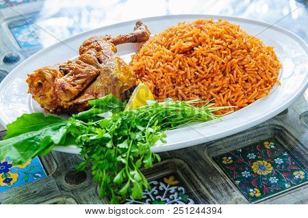 Plate Of Rice With Duck Leg And Greens.