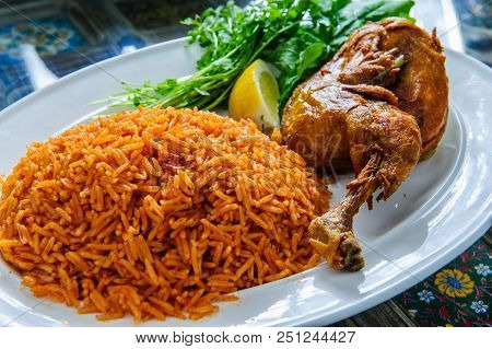 Plate Of Rice With Duck Leg And Greens.