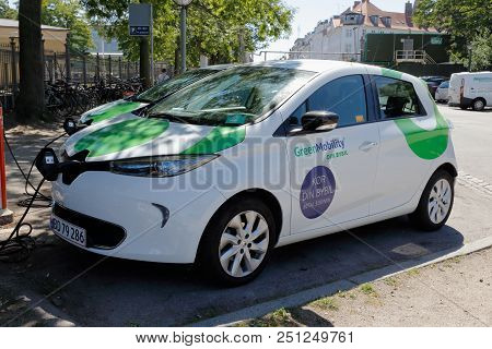 Copenhagen, Denmark - June 27, 2018: Parked Electric Car With Its Charing Cable Connected.