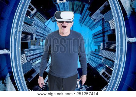 A Very Surprised Old Man In Vr Headset Against A City Buildings Background.