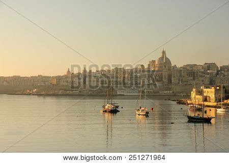 Reflections Of Ships In Water Of The Grand Harbour Of Valletta In Early Morning Sunrise
