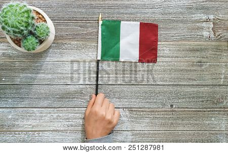 Itialian Flag On A Gray Wooden Desktop