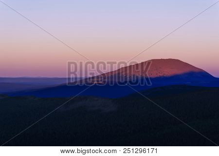 Severe Landscape Of The Northern Mountains With A Peak Illuminated By The Rising Sun