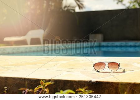 Summer Glass In The Ground With Pool In The Background