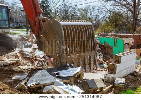 Old House Being Excavator Demolished By A Large Backhoe Wooden Planks And Rubble And The Ruins