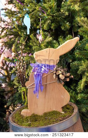 Cute Wood Rabbit And Easter Eggs Hanging On Tree Decorate  During The Season Of Eastertide.