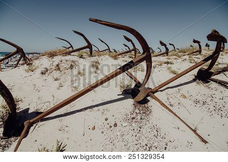 Natural Cemetery Of Marine Anchors At Barril Beach On The Southern Portuguese Coast Of The Atlantic.