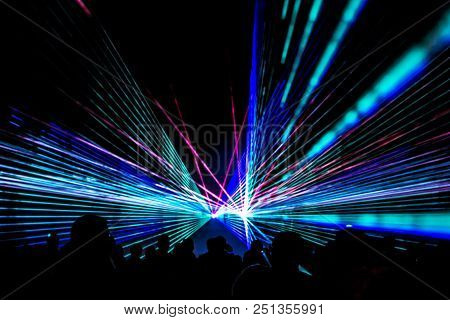 Colorful Laser Show Nightlife Club Stage With Party People Crowd. Luxury Entertainment With Audience