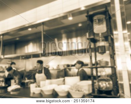 Vintage Blurred Background Chef Preparing For Lunch Service In Asian Restaurant Kitchen