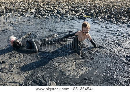Grandfather With His Grandson In Healing Mud, Primorsko-akhtarsk, Russia