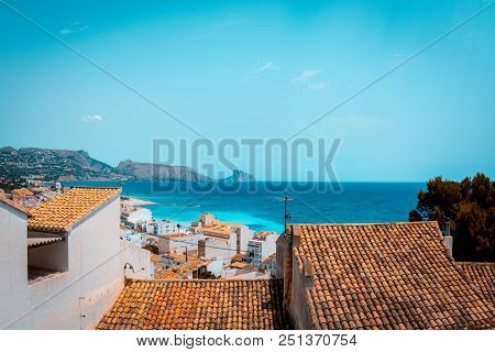 Teal And Orange Look Of Typical White Houses And The Mediterranean Sea Of The Costa Blanca From Alte