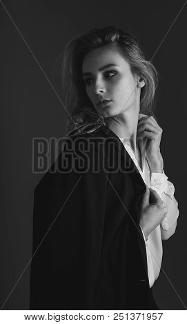 Black And White Portrait Of Blonde Girl In Jacket And White Shirt. Girl Throws A Jacket On Her Shoul