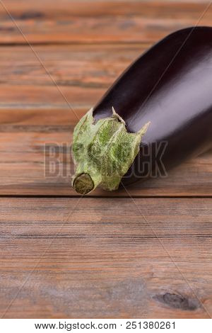 Raw Ripe Vivid Eggpant. Ready For Cooking. Wooden Desk Table Background.
