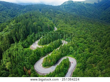 Curved Winding Road Trough The Forest Aerial View. High Mountain Pass. Aerial View