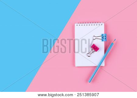 Top View Of Blank Notebook On Colorful Background Pink Blue With Copy Space.