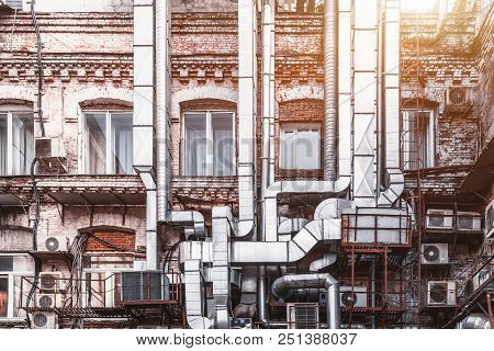 Facade Of An Old Brick Factory Building In Industrial Zone With Plenty Of Air Chimnies, Outdoor Air 