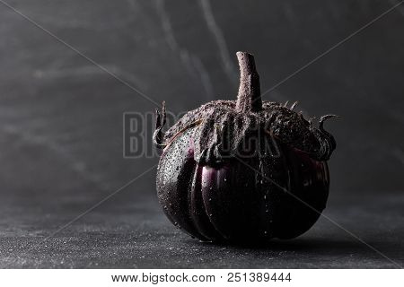 Fresh Italian Type Eggplant Or Aubergine With Water Drops Closeup On Black Background