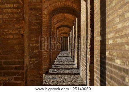 Ancient Architecture Of The Bridge In Isfahan. Narrow Brick Corridor. Iran, Isfahan Province, Esfaha