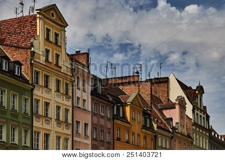 Colorful Historic Buildings With Dramatic Sky In Wroclaw, Poland.