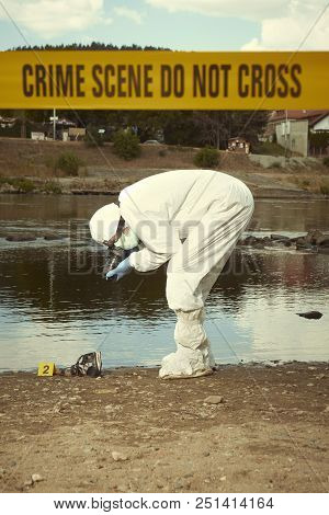 Woman body in black apparel found drowned on summer river bank - collecting of evidences