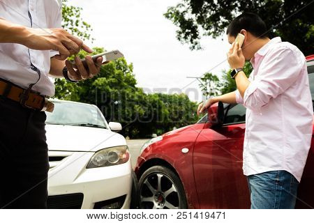 A Man Call Car Insurance For Halp With The Parties From The Car Crash . Insurance Claim Concept .