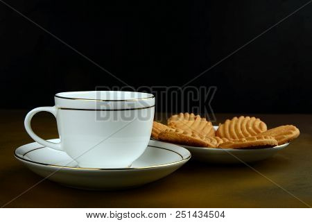 A Tea-cup And Saucer With Some Cookies In Background, Break-fast Table
