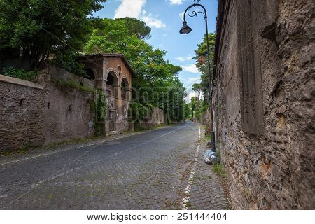 View Of Empty Street San Sebastiano, Rome, Italy. Stone Walls
