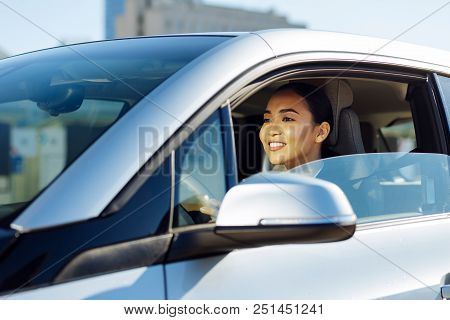 In The Morning. Delighted Attractive Woman Sitting In The Car While Driving To Work