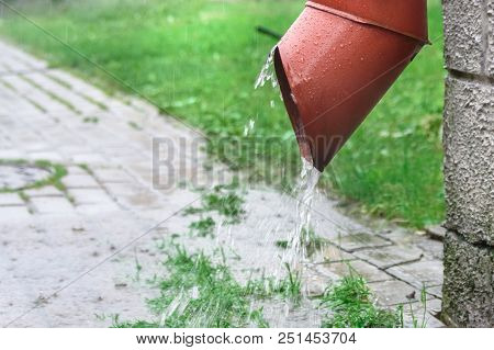 Rainwater Flows From A Drainpipe, Close-up, City