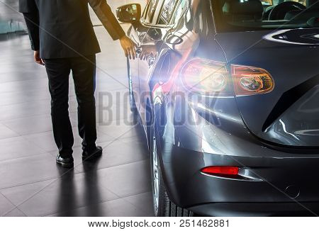 Man Business Saleman Open Door Car On Street Blurry Background.for Automotive Automobile Or Transpor