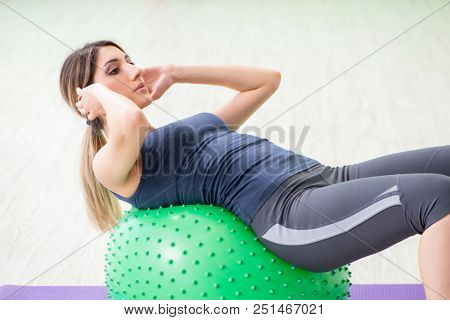 Woman doing exercises with swiss ball