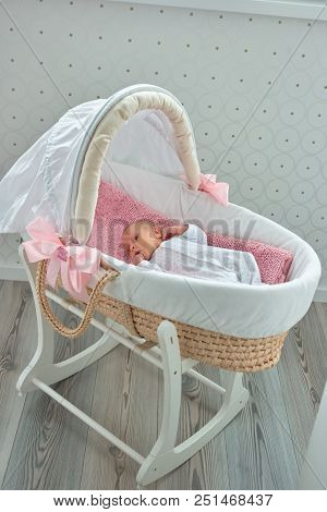 Newborn Little Baby In Moses Basket. Baby In Lullaby Bed Indoor.