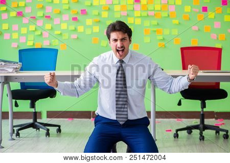 Man in the office with many conflicting priorities doing exercis