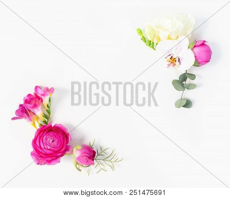 Flowers Composition. Frame Corners Of Eucaliptus Leaves And Ranunculus Flowers On White Background. 
