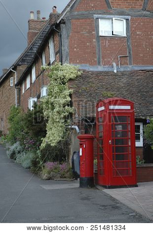 Old Village Scene With Houses, Telephone And Postbox