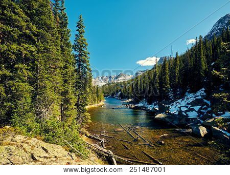 Lake Verna with rocks and mountains around at autumn. Rocky Mountain National Park in Colorado, USA. 