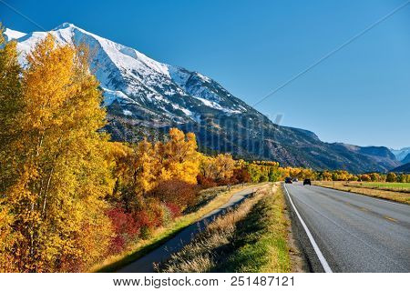 Highway in Colorado Rocky Mountains at autumn, USA. Mount Sopris landscape.