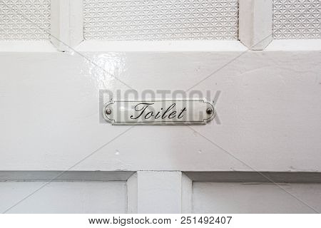 Vintage Toilet Sign With The Words Toilet On A White Wooden Door Public