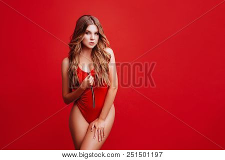 Pretty Bikini Model In Studio On Red Background